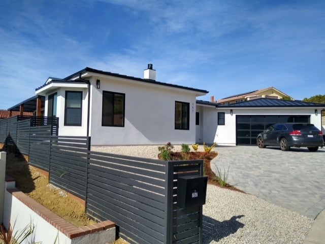 Large white above-ground propane tank in front of a house