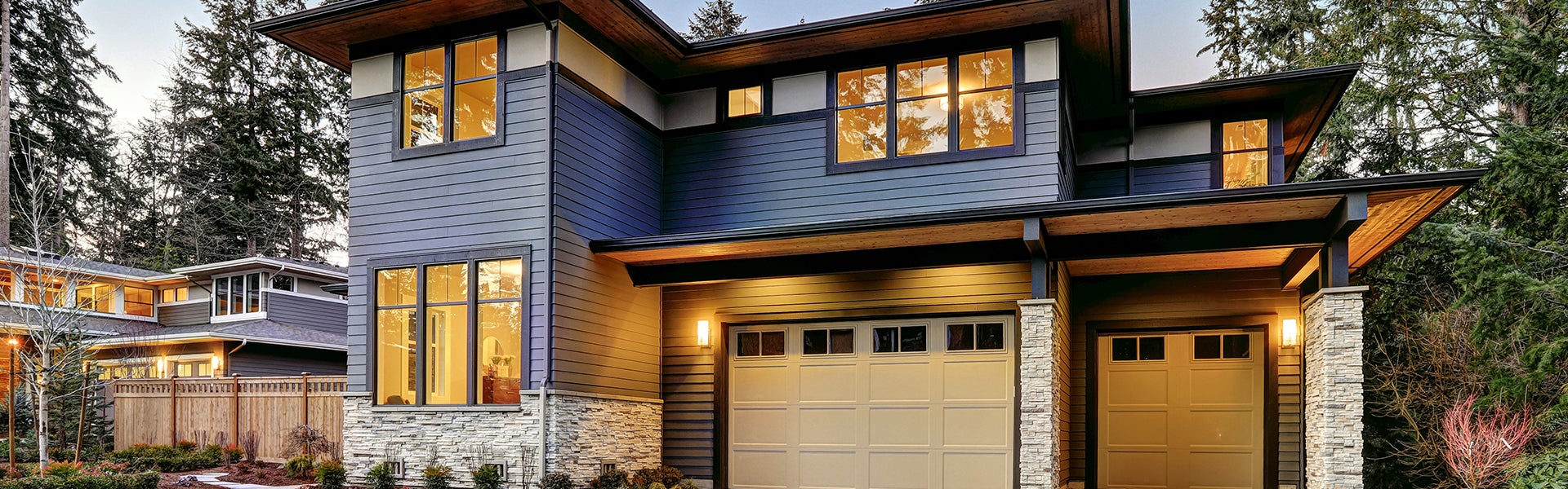 Modern two-story house with blue siding and a two-car garage