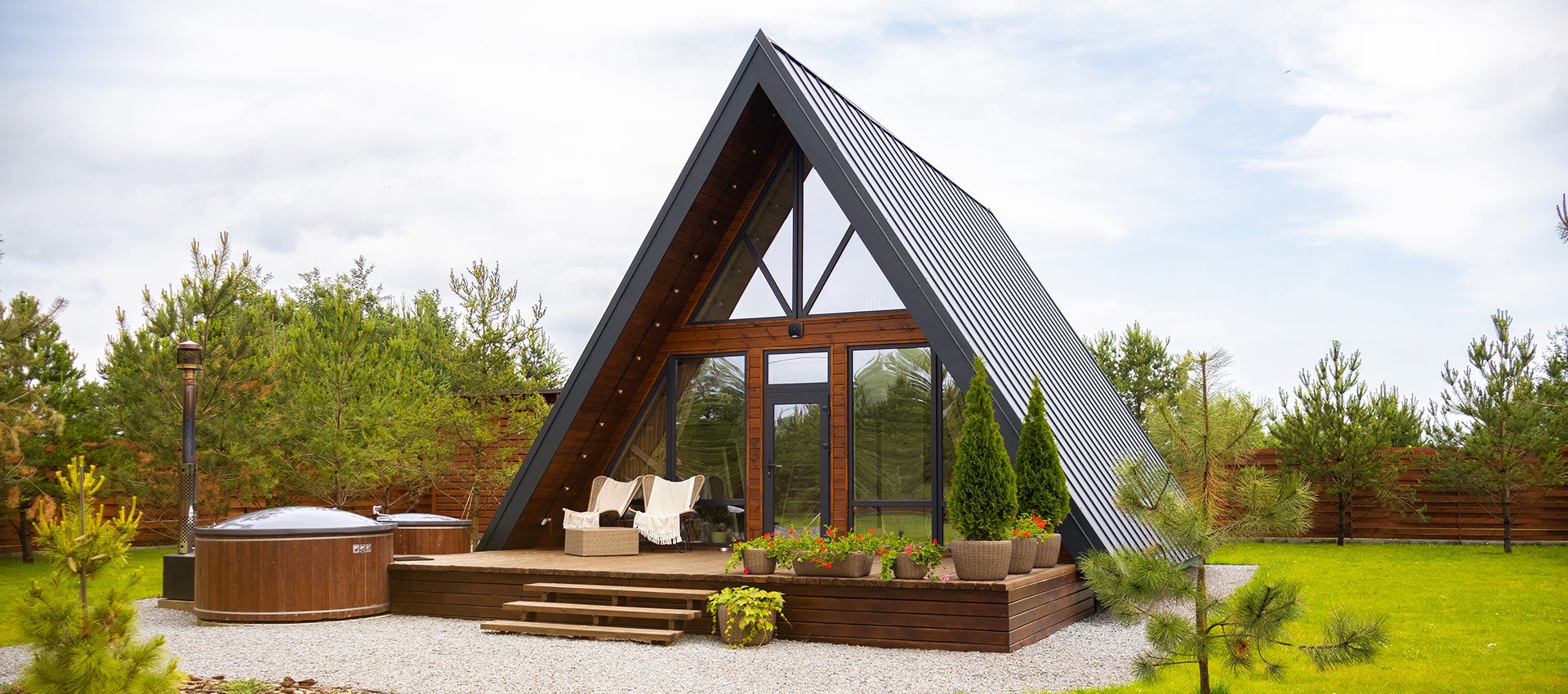 Natural wood siding on the front deck area of an A-frame home.