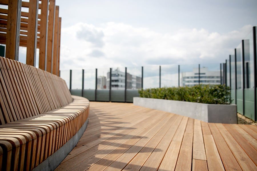 Luxury white and gold marble bathroom with freestanding tub and large window.