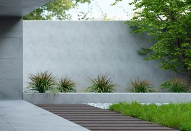 Modern garden with light grey wall and wooden path