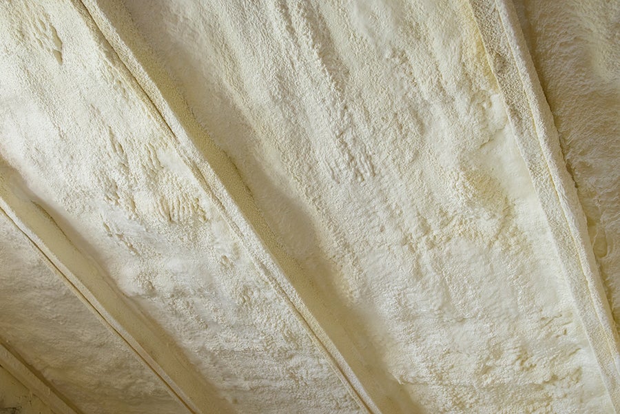 Close-up of yellow spray foam roofing texture.