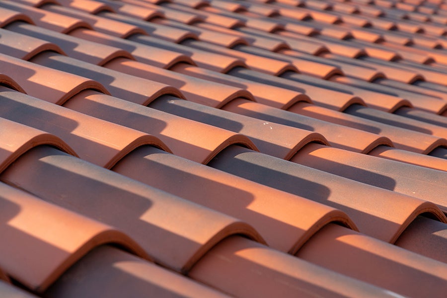 Close-up of a pattern of curved terracotta roof tiles